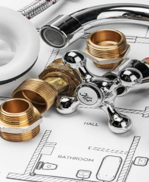 plumbing and tools lying on drawing for repair